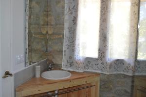 a bathroom with a sink and a mirror at Lo Cel De Tolo in Toló +108 photos