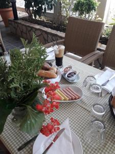 a table with plates of food and a drink on it at Hotel Florakis in Livanates
