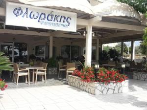 a restaurant with a table and chairs and flowers at Hotel Florakis in Livan&aacute;tai