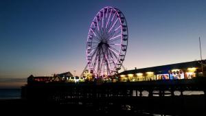 a ferris wheel is lit up at night at Bamford House Hotel in Blackpool