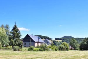 a house in the middle of a field at Gîte Les 4 Saisons in Orbey