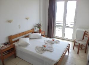 Postel nebo postele na pokoji v ubytování Poseidon Hotel