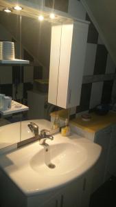 a bathroom with a sink and a mirror at Apartman Daris&Emma in Bihać