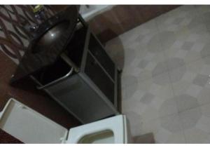 a bathroom with a white toilet in a room at Hotel Pratiksha in Solan