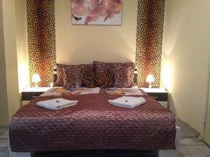 a bedroom with a bed with two towels on it at King Residences in Budapest
