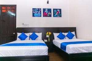 Postel nebo postele na pokoji v ubytování Blue Star Hotel