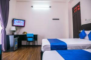 Postel nebo postele na pokoji v ubytování Blue Star Hotel