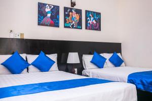 Postel nebo postele na pokoji v ubytování Blue Star Hotel