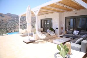 a villa with a view of the mountains at Villa Estée, luxury villa with private infinity pool and jacuzzi in Elounda