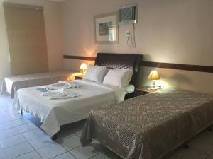 Postel nebo postele na pokoji v ubytování Hotel Pousada Caminho da Praia