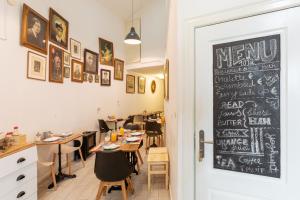 a restaurant with tables and a chalkboard on the wall at Sintra1012 Boutique Guesthouse in Sintra