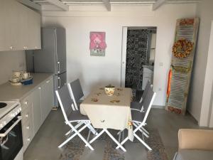 a kitchen with a table and chairs in a kitchen at Ergina Summer Resort in Antiparos