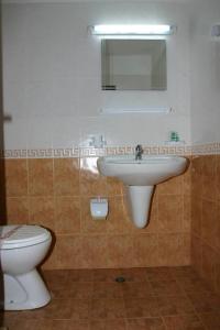 a bathroom with a sink and a toilet at Harmony Beach Family Hotel in Nesebar