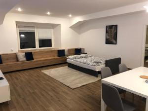 a living room with a bed and a table at Jure apartment in Ljubljana in Ljubljana