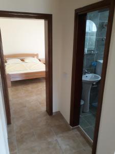 a bedroom with a bed and a sink and a mirror at Korac Apartments in Ulcinj +97 photos