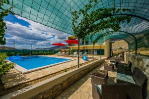 una casa con piscina y techo de cristal en Holiday Home Cherry Tree, en Žrnovnica
