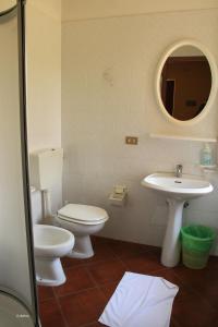 a bathroom with a toilet and a sink at Agriturismo La Praduscella in Fivizzano