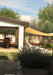 a pavilion with a yellow canopy in a garden at Apartments Morje in Umag