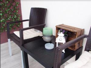 a table with a chair and a green candle on it at Prenočište Dunav in Novi Banovci +6 photos