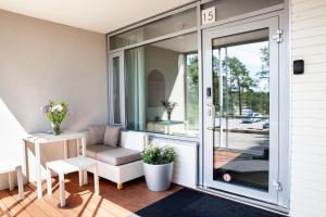 a screened in porch with a sliding glass door at Holiday Home Birdie in Naantali