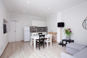 a kitchen and dining room with a table and chairs at La Casa di Mattia in Pula