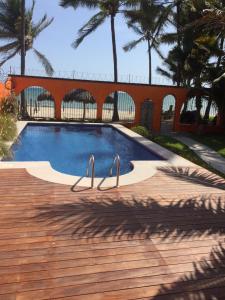 a swimming pool with two metal rails in a yard at Unelma Bungalows in Bucer&iacute;as