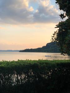 a view of a lake with a boat in the water at Appartamenti Villa Andrea in Garda