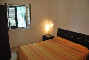 a bedroom with a bed and a window at Residence Paradise in Peschici