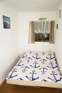 a bed in a corner of a room at Apartamenty Zabrze in Zabrze