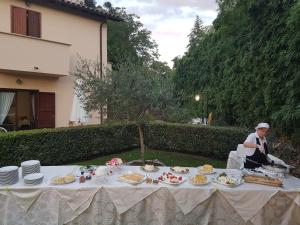 a man sitting at a table with food on it at Case Vacanza Fiocchi in Arrone