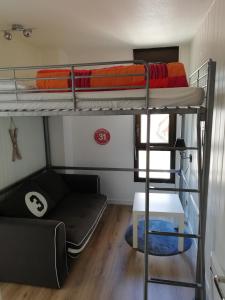 a room with two bunk beds and a couch at Appartement Bagnères de Luchon in Luchon