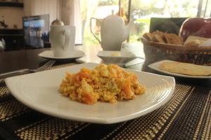a white plate of food on a table at Hotel Casa Iris in Chía