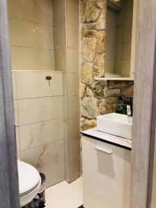 a bathroom with a white toilet and a sink at Villa Stephanie in Hanioti +49 photos