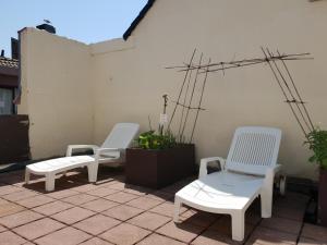 three white chairs sitting on top of a patio at Hotel Albert II Oostende in Ostend