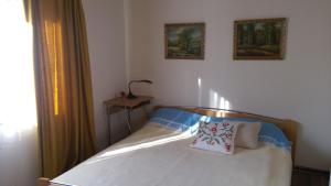 a bedroom with a bed with two pillows on it at Aglonas Līdakas in Priežmale