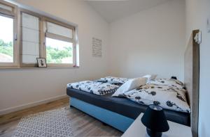 a bedroom with a bed with pillows and a window at Holiday Flat in Sarajevo