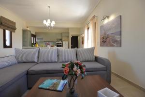 a living room with a couch and a table at Lidromi Home (Blue) in Alonnisos Old Town