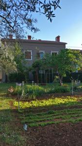 a house with a playground in front of a yard at Apartman Lovor in Medulin
