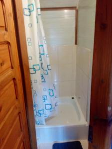 a bath tub with a shower curtain in a bathroom at aura in Suwałki
