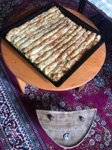 a pan of food sitting on top of a table at Etno-house Lukomir in Lukomir