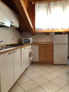 a kitchen with white appliances and a window at Residence Moresco in Lido di Jesolo