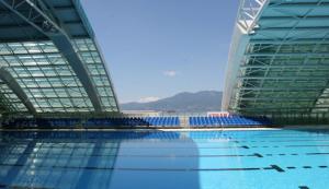 a swimming pool with blue chairs in a building at Apartment Anai Rijeka in Rijeka