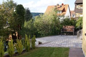 a garden with a bench sitting on a patio at Ferienwohnung Duttental in Tuttlingen