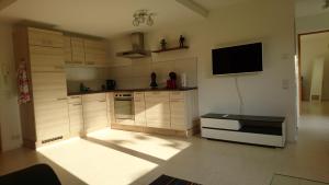 a kitchen with a tv on the wall at Ferienwohnung Duttental in Tuttlingen