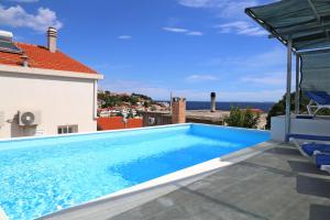 a swimming pool on the roof of a house at Villa Korculaholidays in Zavalatica