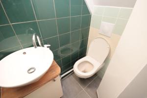 a bathroom with a sink and a toilet at YMMO 93500 in Pantin