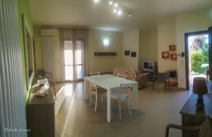 a living room with a white table and chairs at Nel Cuore Del Salento in San Donato di Lecce