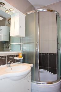 a bathroom with a sink and a shower at Apartments Sv. Jelena 2 in Pag +41 photos