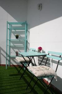 a table with two chairs and a glass shelf at CLB Feria Apartment in Seville