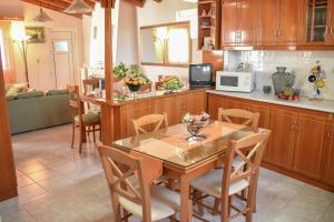 a kitchen with a table and chairs in a room at Mayra Apartment in Lithakia